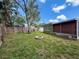 Spacious backyard featuring a fire pit and a fenced perimeter for privacy and relaxation at 5415 Riddle Rd, Holiday, FL 34690
