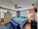Bedroom featuring a bed, a ceiling fan, and a window at 5415 Riddle Rd, Holiday, FL 34690