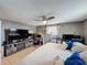 Comfortable bedroom with a ceiling fan, a window, a double bed and a big tv at 5415 Riddle Rd, Holiday, FL 34690