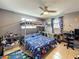 Bedroom featuring bunk beds, a ceiling fan, window and a desk with an rolling office chair at 5415 Riddle Rd, Holiday, FL 34690