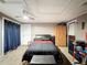 A cozy bedroom features a ceiling fan, closet, and comfortable furnishings at 5415 Riddle Rd, Holiday, FL 34690