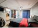 A cozy bedroom features a bed with red and black bedding at 5415 Riddle Rd, Holiday, FL 34690