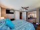 View of the bedroom, featuring a bed and a view of an outdoor gym area at 5415 Riddle Rd, Holiday, FL 34690