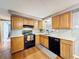 Well-lit kitchen with white countertops, stainless steel appliances, and beautiful light wood cabinets at 5415 Riddle Rd, Holiday, FL 34690