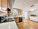 Efficient kitchen with black appliances, bright countertops, and plenty of storage space in light wood cabinets at 5415 Riddle Rd, Holiday, FL 34690
