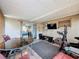 Enclosed sun room with glass doors, large rug, and exercise equipment for your enjoyment at 5415 Riddle Rd, Holiday, FL 34690
