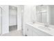 Modern bathroom featuring double sinks, quartz countertops, and a walk-in shower at 7728 Gilchrist Springs Dr, Parrish, FL 34219