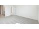 Carpeted bedroom featuring a view to the bathroom and walk-in closet at 7728 Gilchrist Springs Dr, Parrish, FL 34219