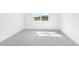 A clean and bright bedroom with a large window showcasing the view at 7728 Gilchrist Springs Dr, Parrish, FL 34219