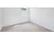 Bedroom features a bright window, neutral walls, and plush carpet at 7728 Gilchrist Springs Dr, Parrish, FL 34219