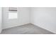 Comfortable bedroom includes a bright window, carpeted floors, and neutral wall colors at 7728 Gilchrist Springs Dr, Parrish, FL 34219
