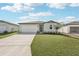 Beautiful home exterior with a well-maintained lawn and appealing curb appeal at 7728 Gilchrist Springs Dr, Parrish, FL 34219