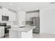 Bright, modern kitchen with stainless steel appliances, island, and sleek white cabinetry at 7728 Gilchrist Springs Dr, Parrish, FL 34219