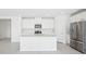 Open concept kitchen with stainless steel appliances and large island with ample counter space at 7728 Gilchrist Springs Dr, Parrish, FL 34219