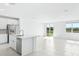 Bright, open kitchen with stainless steel appliances, island, and view of the backyard at 7728 Gilchrist Springs Dr, Parrish, FL 34219