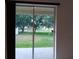 View of the backyard through sliding glass doors at 10415 Lucaya Dr, Tampa, FL 33647