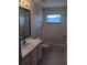 Bright bathroom featuring a shower-tub combo, and a window for ventilation at 10415 Lucaya Dr, Tampa, FL 33647
