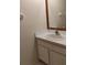 This bathroom features a wood-trimmed mirror and a white countertop with sink at 10415 Lucaya Dr, Tampa, FL 33647