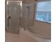 Bright bathroom features a glass shower and a relaxing tub with blinds offering natural light at 10415 Lucaya Dr, Tampa, FL 33647