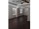 Spacious bedroom with dark wood floors, tray ceilings, ceiling fan and lots of light at 10415 Lucaya Dr, Tampa, FL 33647