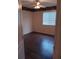 The bedroom offers a ceiling fan, dark wood floor, and a bright window at 10415 Lucaya Dr, Tampa, FL 33647