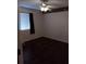 This bedroom features dark wood floors, ceiling fan, and a window with blinds at 10415 Lucaya Dr, Tampa, FL 33647