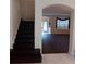 Entryway featuring dark wood steps and floors with a view to the main living area at 10415 Lucaya Dr, Tampa, FL 33647