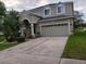 Charming two-story home with a wide driveway and well-maintained lawn at 10415 Lucaya Dr, Tampa, FL 33647