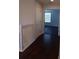 Upstairs hallway featuring wood floors, white railings and view of room with window at 10415 Lucaya Dr, Tampa, FL 33647