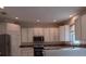 Bright, open kitchen with white cabinets and stainless steel appliances at 10415 Lucaya Dr, Tampa, FL 33647