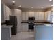 Bright, open kitchen with white cabinets and stainless steel appliances at 10415 Lucaya Dr, Tampa, FL 33647