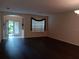 Open-concept living room with dark wood floors and plenty of natural light at 10415 Lucaya Dr, Tampa, FL 33647