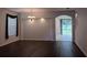 Well-lit living room featuring wood floors, neutral paint, and an archway to another room at 10415 Lucaya Dr, Tampa, FL 33647