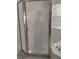 Glass enclosed shower with a frosted art deco design and window views at 10415 Lucaya Dr, Tampa, FL 33647
