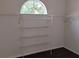 Walk-in closet with wire shelving and a unique arched window for natural light at 10415 Lucaya Dr, Tampa, FL 33647