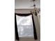 View of window with decorative cornice and light fixture above at 10415 Lucaya Dr, Tampa, FL 33647