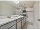 The bathroom showcases a double sink vanity, tiled floor, and a shower-tub combination at 13083 Burns Dr, Odessa, FL 33556