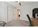 Neutral bedroom with a ceiling fan, closet and desk, offering a versatile and comfortable space at 13083 Burns Dr, Odessa, FL 33556