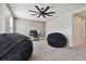 Spacious bedroom featuring a ceiling fan and two bean bag chairs offers a relaxing, comfortable space at 13083 Burns Dr, Odessa, FL 33556