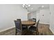A classic dining room offers a round wood table with seating and stylish wood-look floors at 13083 Burns Dr, Odessa, FL 33556
