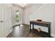 Foyer with wood-look tile and decoratively appointed table at 13083 Burns Dr, Odessa, FL 33556