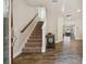 Inviting foyer with wood-look tile flooring and staircase leading to upper level at 13083 Burns Dr, Odessa, FL 33556