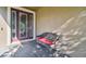 Close-up of front door with leaded glass and a bench seat on a paved porch at 13083 Burns Dr, Odessa, FL 33556