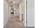 Carpeted hallway with recessed lighting leads to various rooms for easy navigation within the home at 13083 Burns Dr, Odessa, FL 33556
