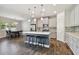 Spacious open-concept kitchen and dining area with island seating and modern appliances at 13083 Burns Dr, Odessa, FL 33556