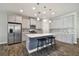 Bright kitchen features an island with seating, stainless steel appliances, and ample counter space at 13083 Burns Dr, Odessa, FL 33556