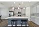 An open kitchen with an island and seating provides a seamless cooking and socializing experience at 13083 Burns Dr, Odessa, FL 33556