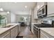 An eat-in kitchen with stainless steel appliances and an open view to the dining area at 13083 Burns Dr, Odessa, FL 33556