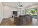 Spacious living room with a modern TV console and sliding glass doors to the backyard at 13083 Burns Dr, Odessa, FL 33556