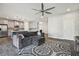 Open living room with a large sectional couch and connecting view of the kitchen at 13083 Burns Dr, Odessa, FL 33556